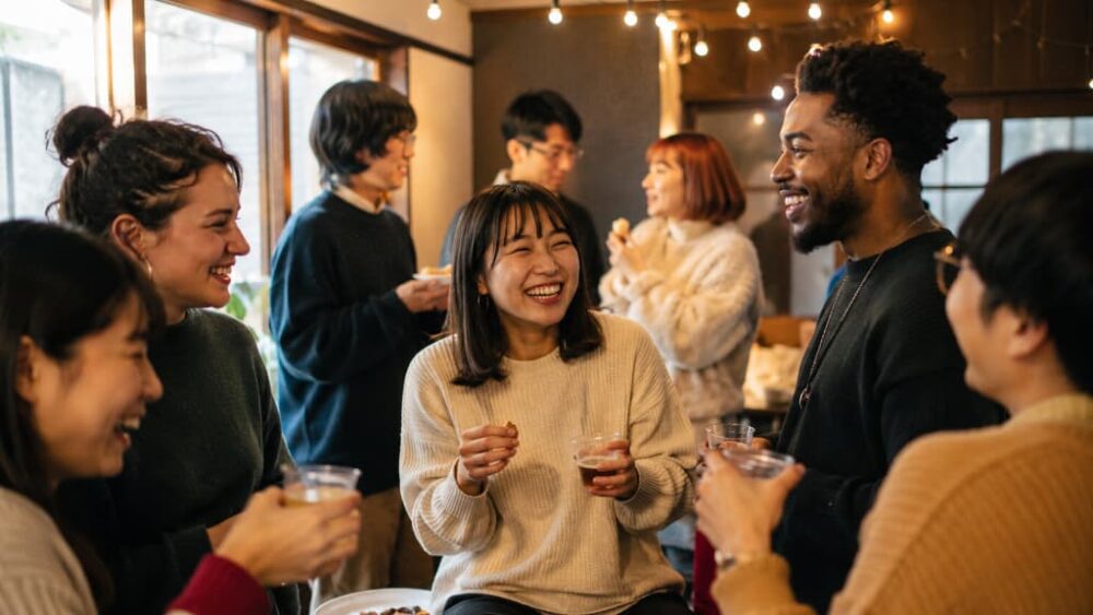 Foreigners and Japanese friends socializing at a gathering, finding community in Japan as an expat