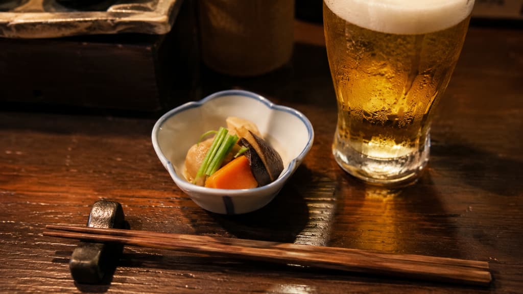 A small otōshi appetizer served with a drink at a Japanese izakaya as a cover charge