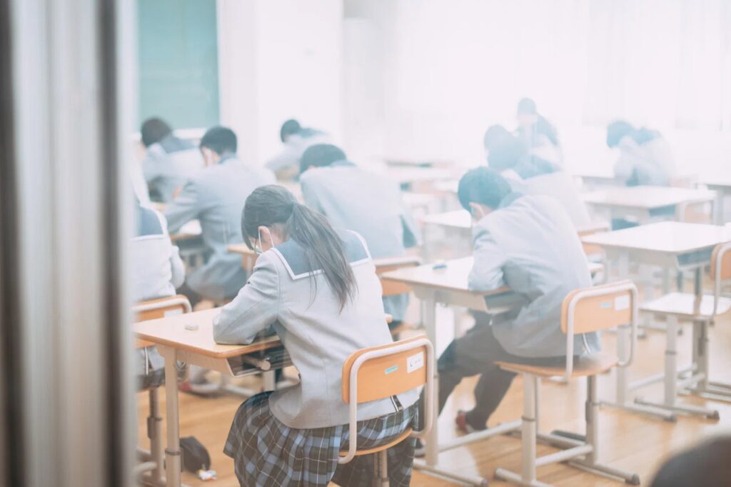 Students sitting a Japanese university entrance exam, part of how admissions work in Japan