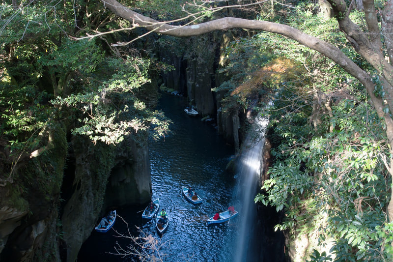 A rowboat beneath Manai Falls in the volcanic cliffs of Takachiho Gorge, Miyazaki