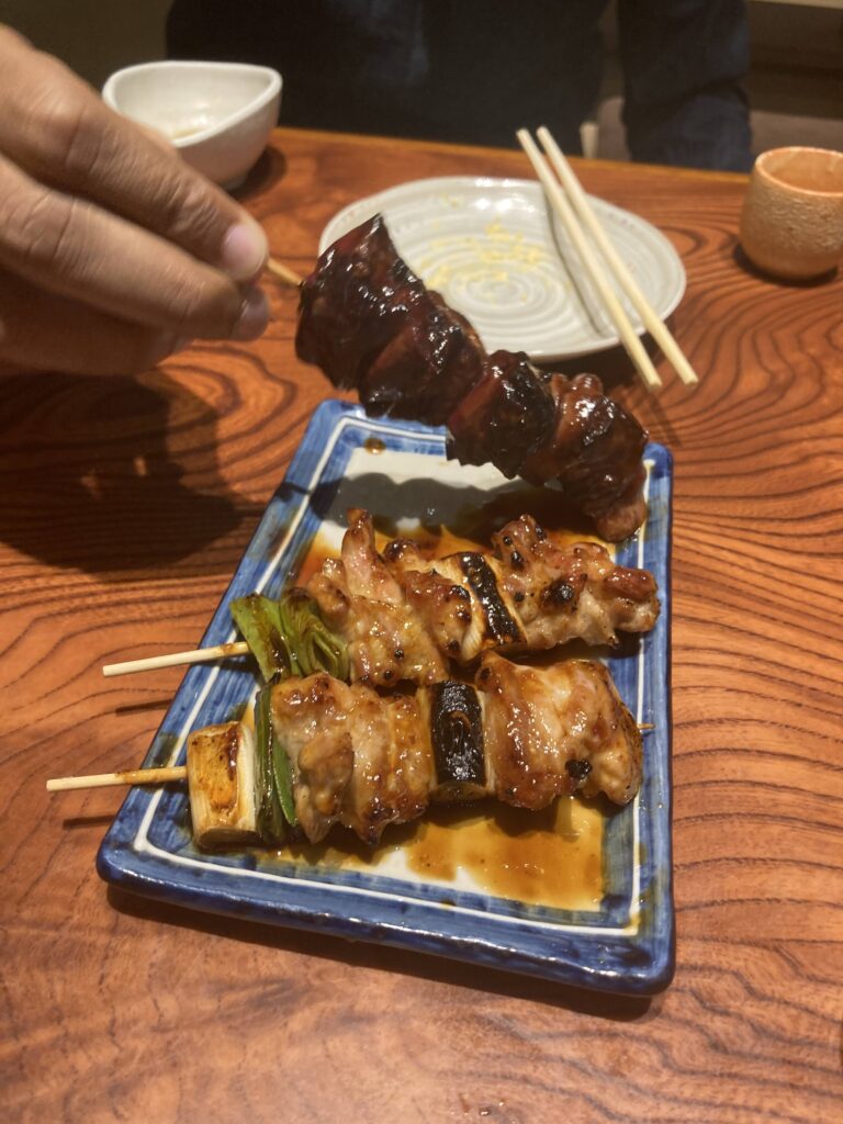 Grilled yakitori skewers and small plates at a Japanese izakaya
